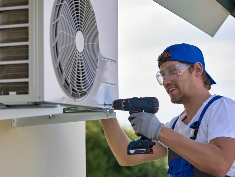 Technician installing outdoor AC bracket
